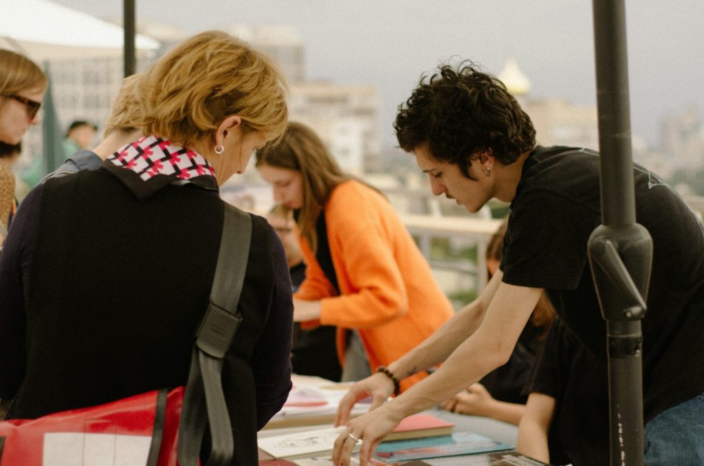 a group of people standing around a table